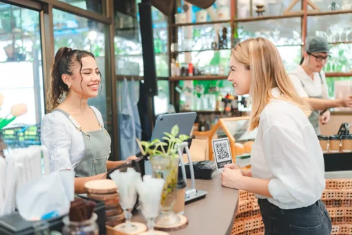 gestão de bares e restaurantes - Jovem empresária atende novos clientes em sua cafeteria