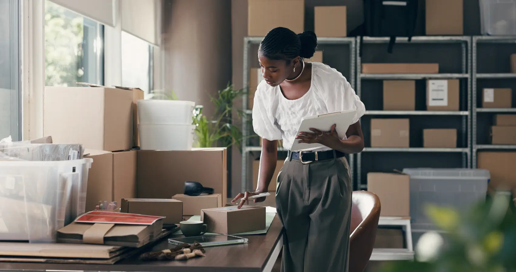 e-commerce-no-brasil - Comércio eletrônico, caixa e prancheta com mulher negra no armazém para transporte, distribuição e correio